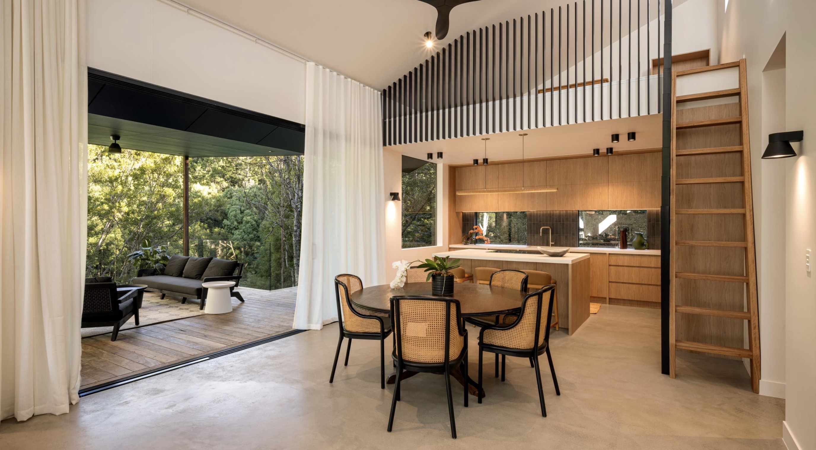 Tallowood kitchen and dining space opening to its bushland setting.